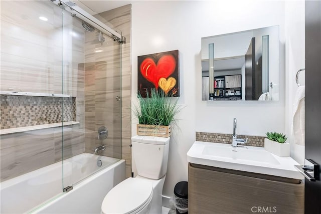 full bathroom with tasteful backsplash, bath / shower combo with glass door, vanity, and toilet