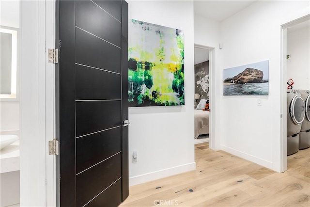 interior space with independent washer and dryer and wood-type flooring