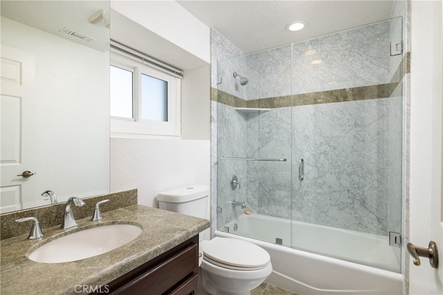 full bathroom with toilet, enclosed tub / shower combo, vanity, and a textured ceiling