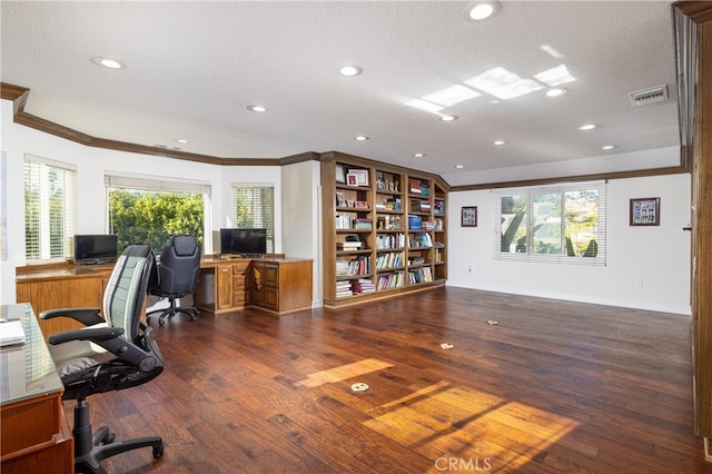 office with ornamental molding, a textured ceiling, a healthy amount of sunlight, and dark hardwood / wood-style flooring