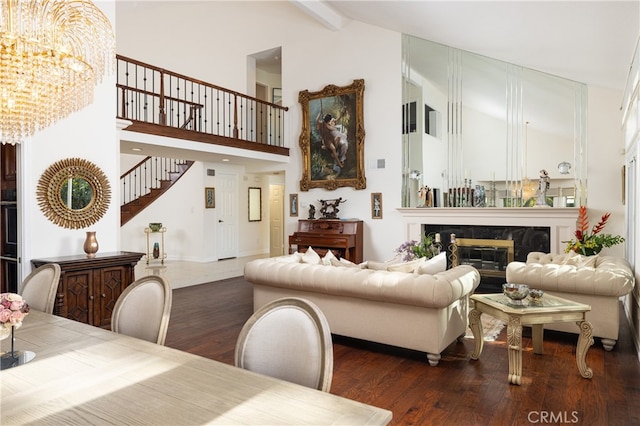 living room featuring a premium fireplace, beamed ceiling, high vaulted ceiling, and dark hardwood / wood-style flooring