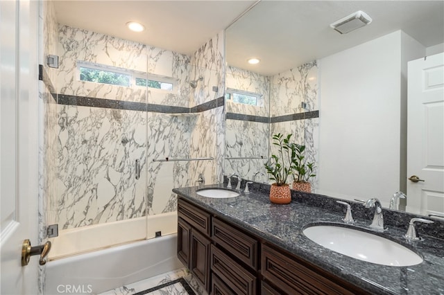 bathroom featuring vanity and tiled shower / bath