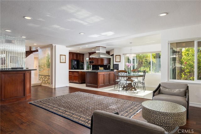 living room featuring sink, a textured ceiling, and dark hardwood / wood-style flooring