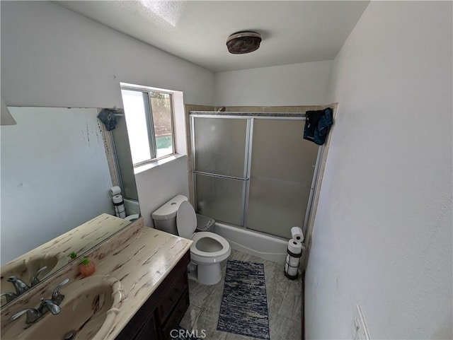 full bathroom featuring vanity, hardwood / wood-style flooring, toilet, and enclosed tub / shower combo