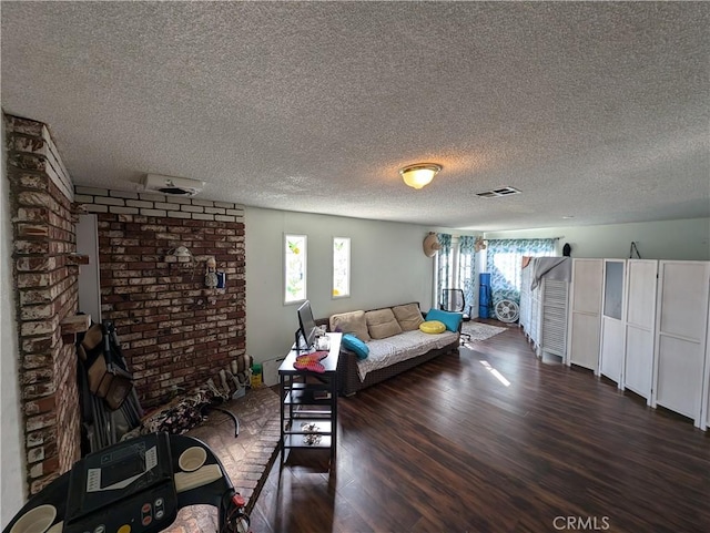 unfurnished living room featuring a textured ceiling and dark wood-type flooring