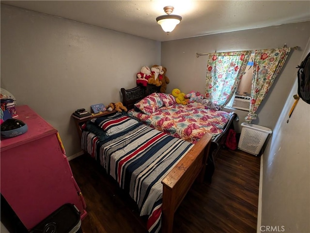 bedroom with dark hardwood / wood-style flooring