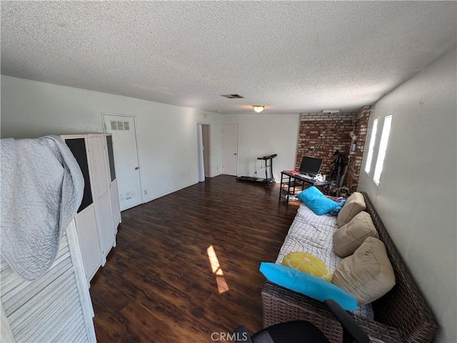 living room featuring a textured ceiling and dark hardwood / wood-style flooring