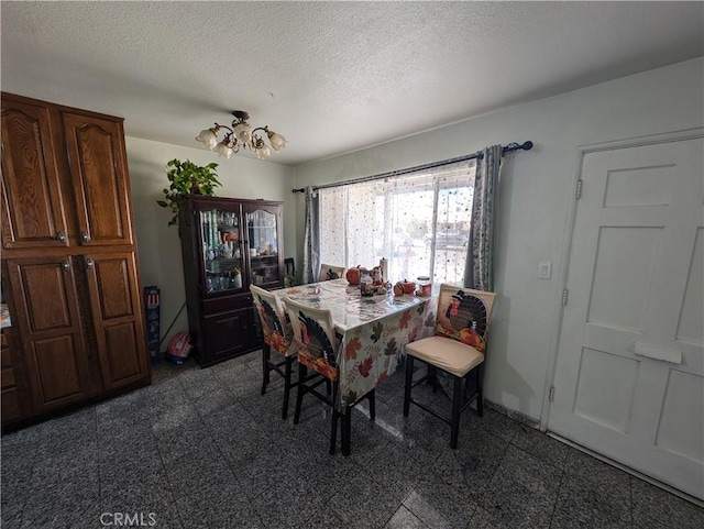 dining space featuring a textured ceiling