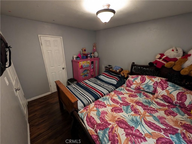 bedroom with dark hardwood / wood-style flooring