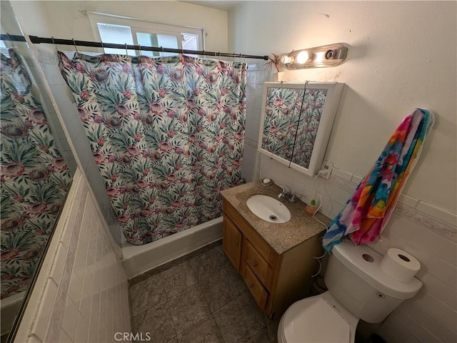 bathroom featuring vanity, a shower with shower curtain, tile walls, and toilet