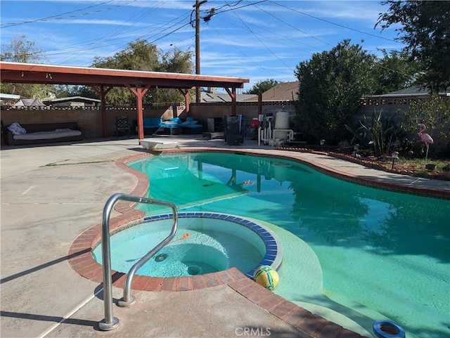 view of pool featuring a patio area and an in ground hot tub