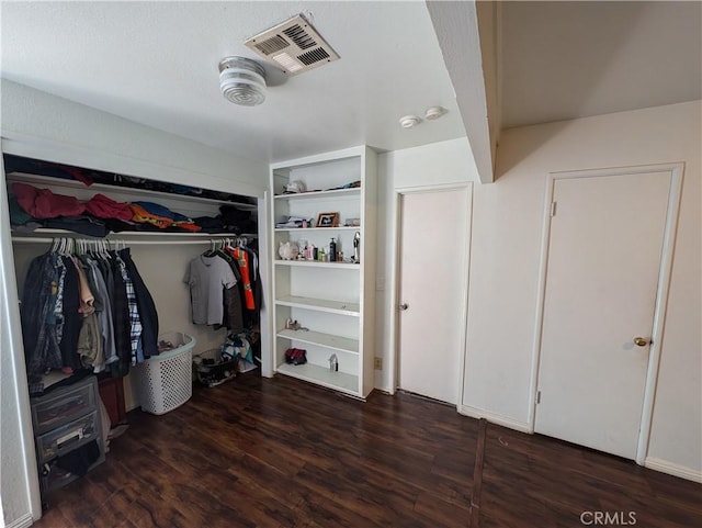 spacious closet with dark hardwood / wood-style floors