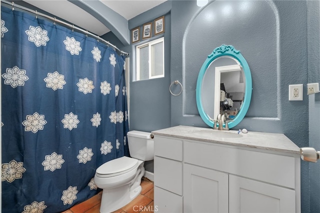 bathroom featuring toilet, vanity, and tile patterned floors