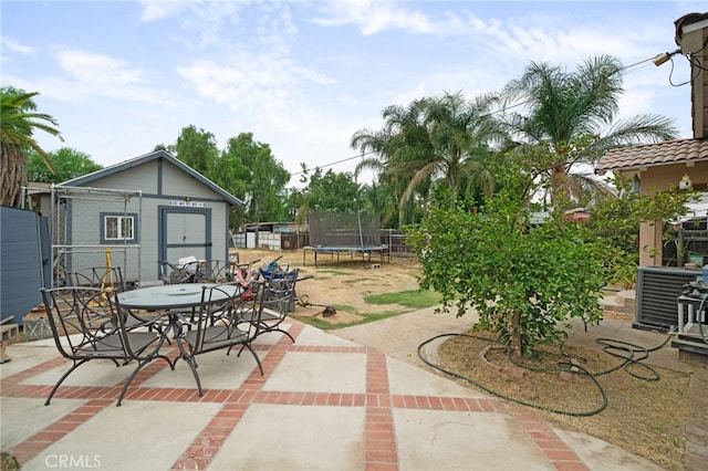 view of patio with central AC unit and a trampoline