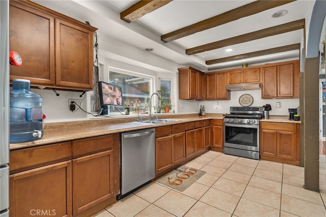 kitchen featuring sink, beamed ceiling, stainless steel appliances, and light tile patterned floors