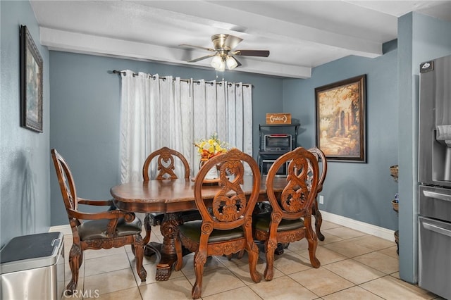 dining area featuring beamed ceiling, light tile patterned floors, and ceiling fan