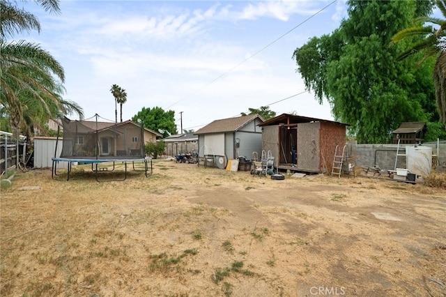 view of yard with a storage unit and a trampoline