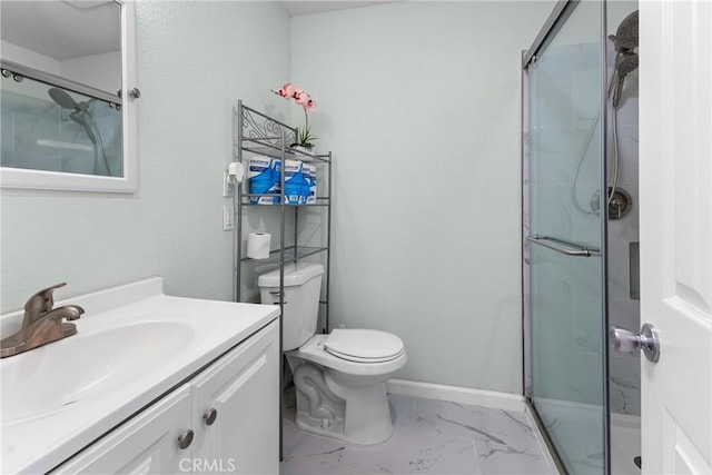 bathroom with vanity, a shower with shower door, and toilet