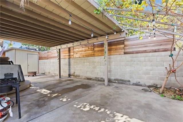 view of patio featuring a storage unit