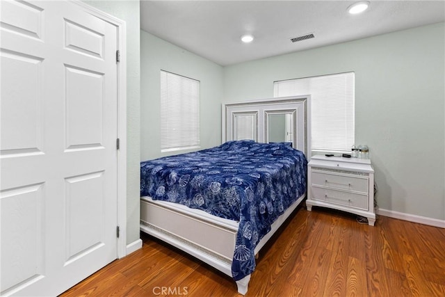 bedroom with hardwood / wood-style floors