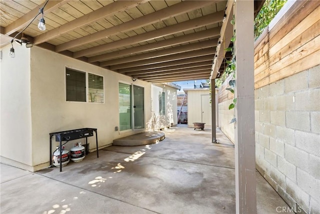 view of patio / terrace featuring a storage unit