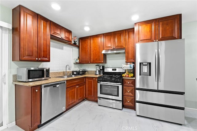 kitchen with light stone countertops, sink, and stainless steel appliances