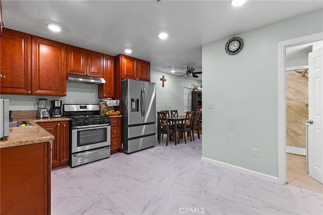 kitchen featuring ceiling fan, light stone countertops, and appliances with stainless steel finishes