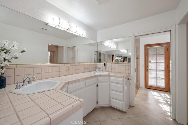 bathroom with vanity, backsplash, and tile patterned flooring