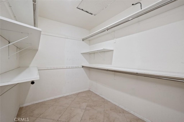 spacious closet featuring light tile patterned flooring