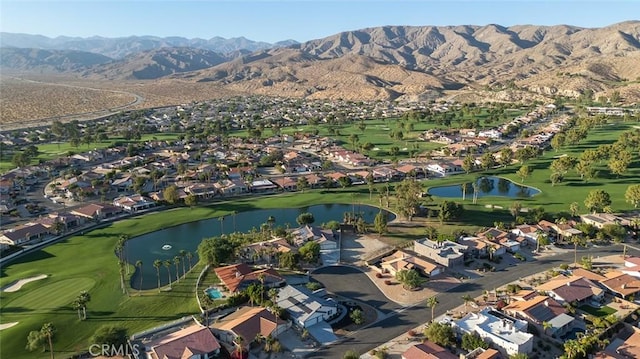 drone / aerial view with a water and mountain view