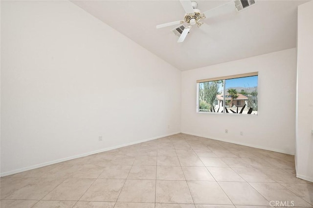 spare room featuring vaulted ceiling, light tile patterned floors, and ceiling fan