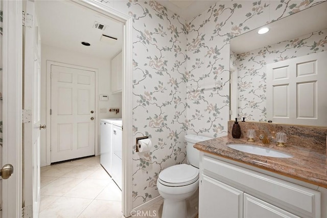 bathroom with tile patterned floors, vanity, toilet, and washer and clothes dryer