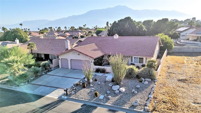 view of front of home with a mountain view and a garage