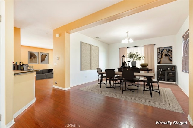 dining room with an inviting chandelier and hardwood / wood-style floors