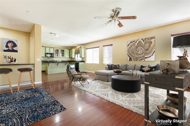 living room featuring ceiling fan and hardwood / wood-style floors