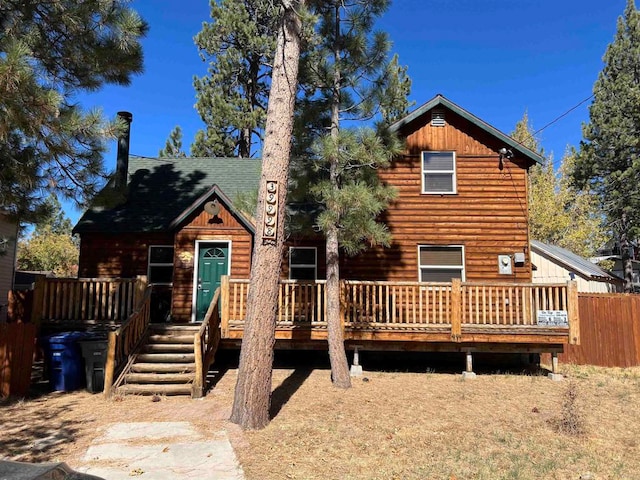 rear view of property featuring a deck