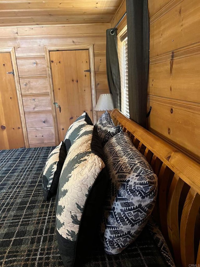 bedroom featuring wooden walls