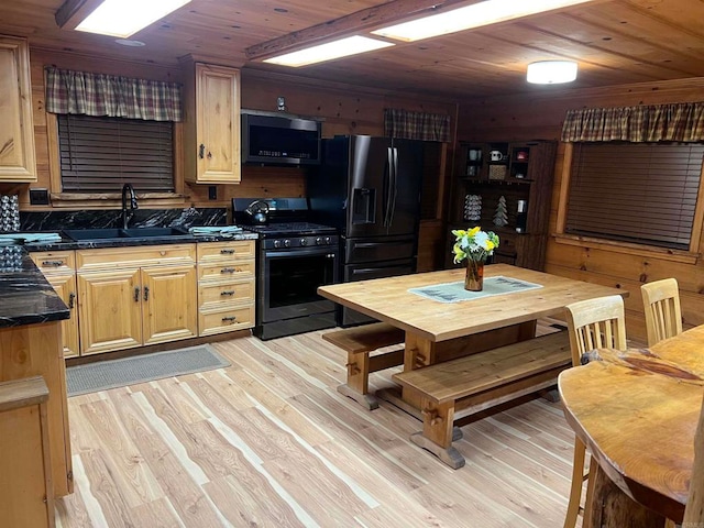 kitchen featuring light hardwood / wood-style flooring, black appliances, sink, and wood ceiling