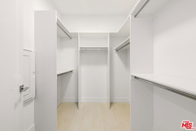 walk in closet featuring light hardwood / wood-style flooring