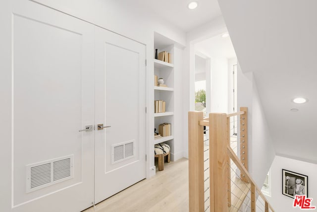 hallway with light wood-type flooring