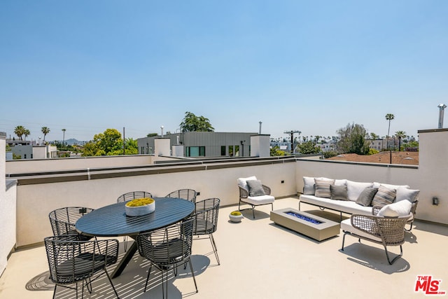 view of patio / terrace with an outdoor living space with a fire pit