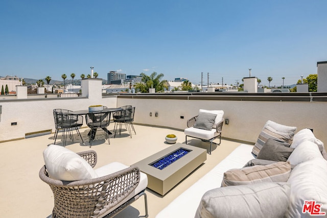 view of patio / terrace featuring an outdoor living space with a fire pit