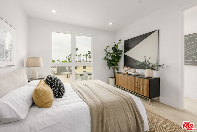 bedroom with hardwood / wood-style floors