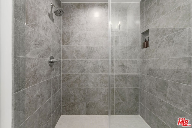 bathroom with tiled shower