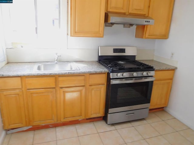 kitchen with stainless steel range with gas cooktop, sink, and light tile patterned floors