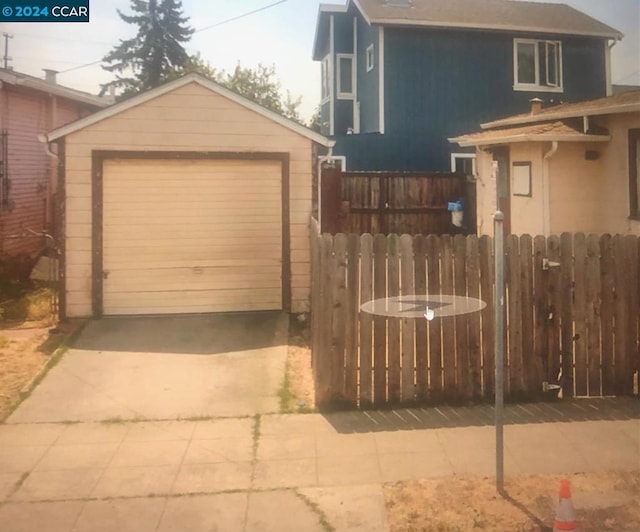 view of property exterior with a garage and an outdoor structure