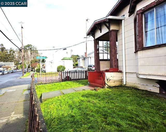 view of side of home with a lawn