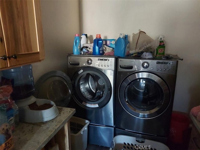 laundry area with cabinets and washing machine and dryer