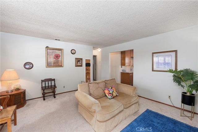 living room featuring light colored carpet and a textured ceiling