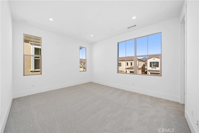 carpeted empty room featuring plenty of natural light